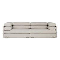 Soft beige sectional sofa with streamlined design and plush round cushions for contemporary living spaces.