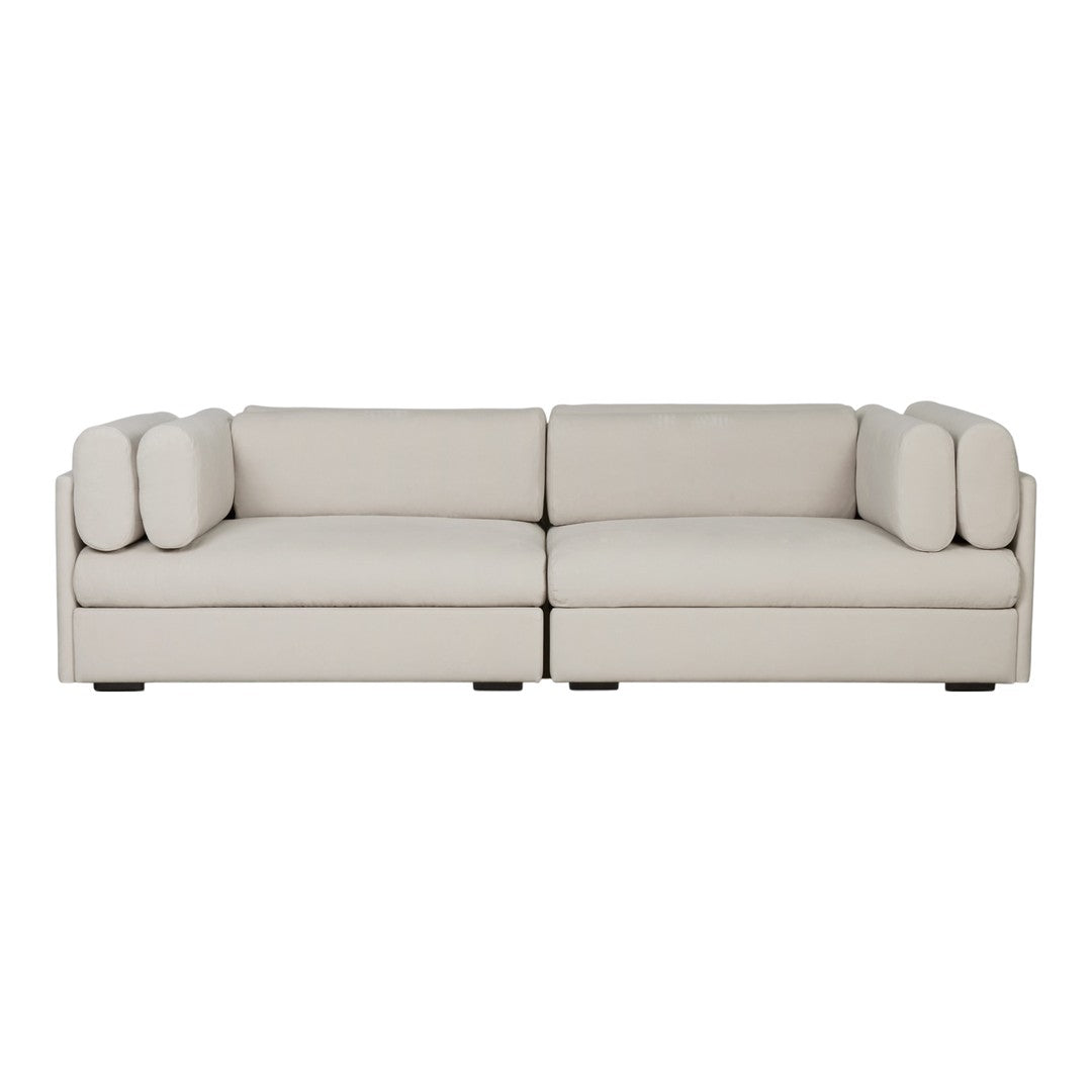 Light gray modern sofa with soft, smooth fabric and rounded cushions, creating a minimalist and elegant look.