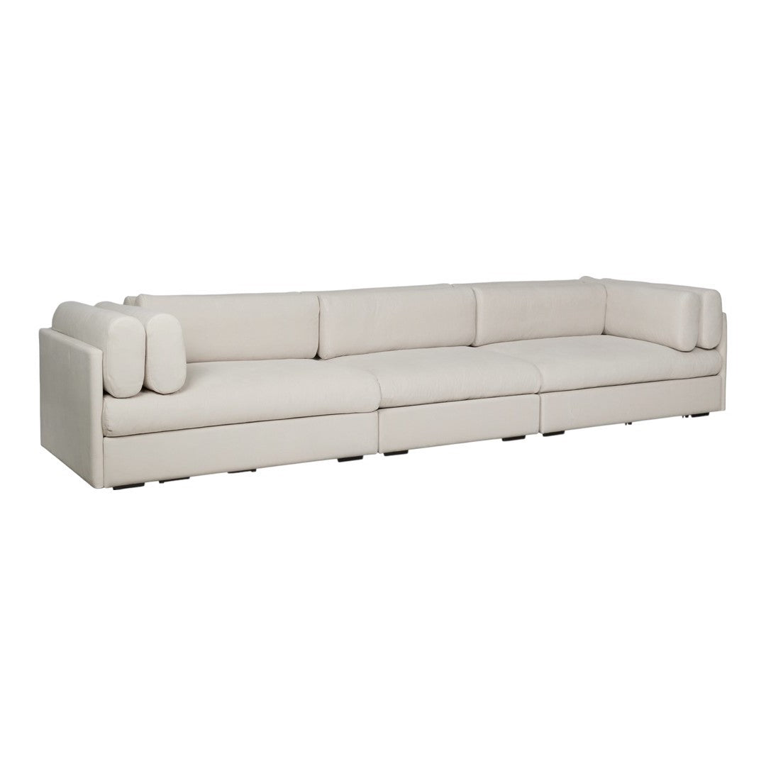 Sleek beige sectional sofa with smooth upholstery and rounded cushions, perfect for modern living spaces.