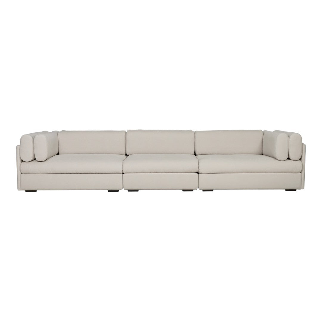 Light beige sectional sofa with smooth upholstery and subtle, contemporary design. Perfect for modern living spaces.