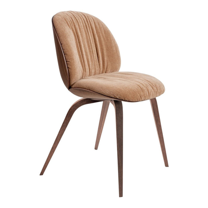 Beige upholstered chair with ribbed texture and elegant wooden legs, adding a touch of warmth to any space.