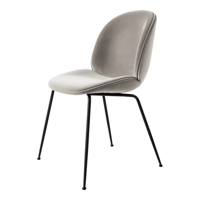 Elegant gray velvet chair with smooth curves and sleek black metal legs, perfect for modern decor.