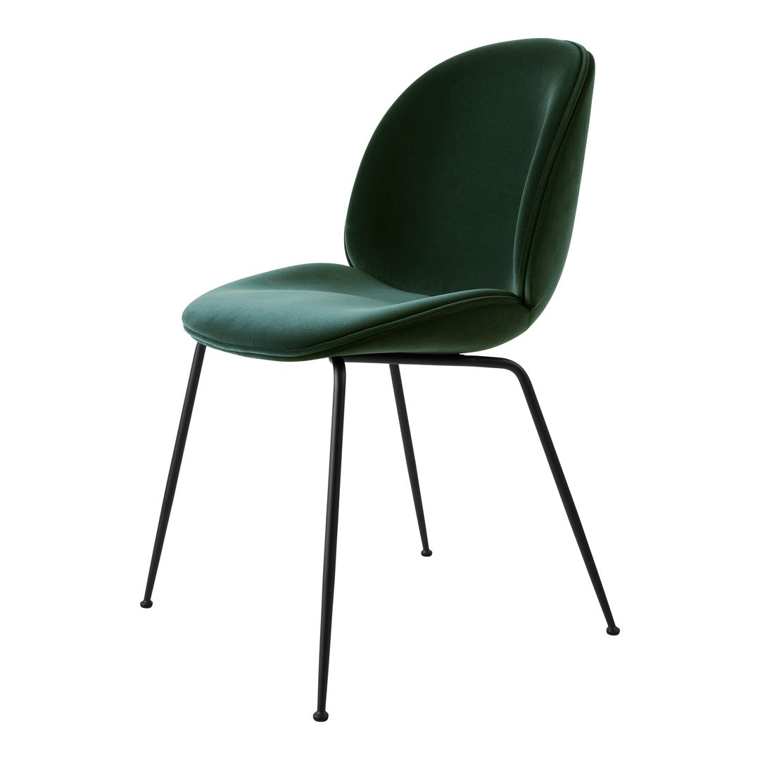 Green upholstered chair with a smooth surface and sleek black metal legs. Ideal for modern interiors.