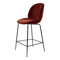 Rust-colored bar stool with a smooth, curved seat and sleek black metal legs, perfect for modern interiors.