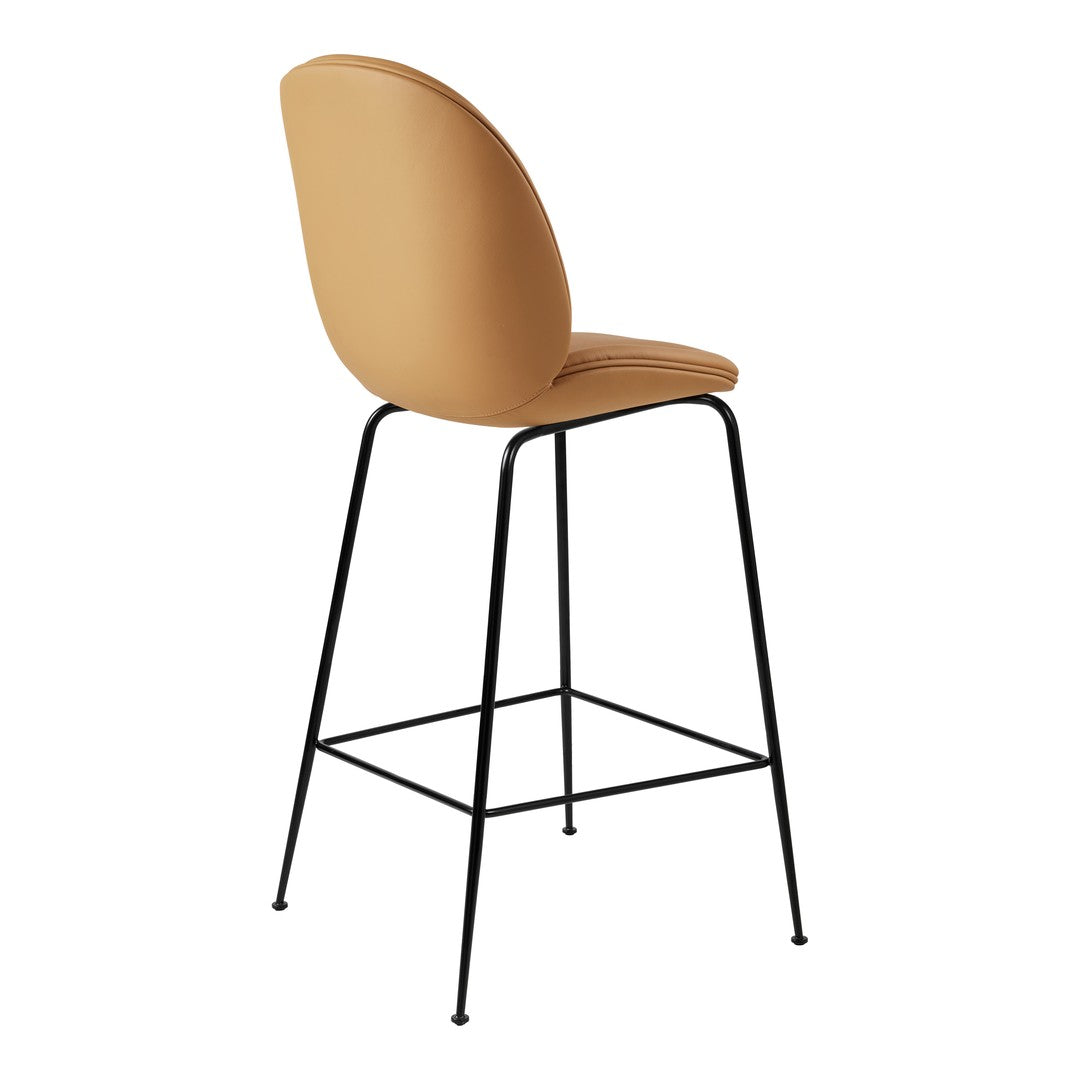 Tan upholstered bar stool with a sleek black metal frame and smooth curved backrest for modern decor.