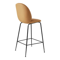 Tan upholstered bar stool with a sleek black metal frame and smooth curved backrest for modern decor.