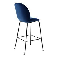 Stylish blue velvet bar stool with a sleek black metal frame. Modern design adds elegance to any space.