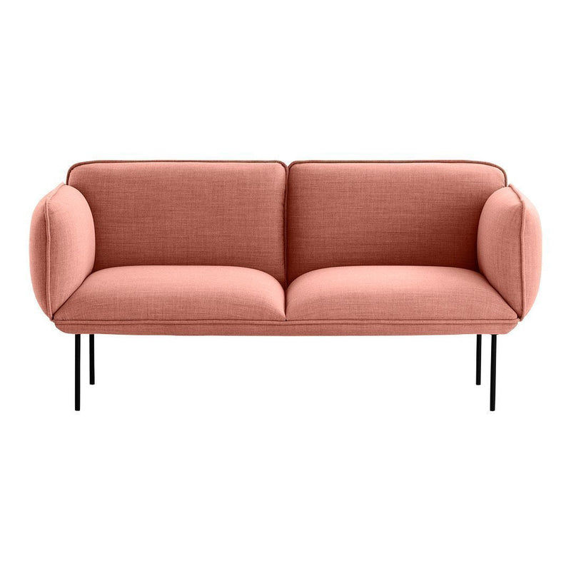 Stylish two-seater sofa in soft coral upholstery with smooth fabric and minimalist black metal legs.
