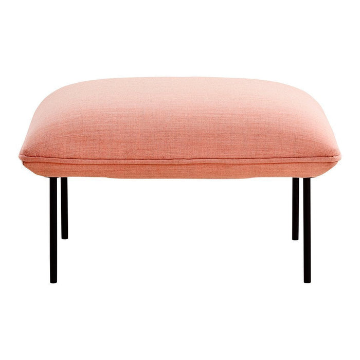 Pink upholstered ottoman with a smooth texture and sleek black legs. Ideal for modern home decor.