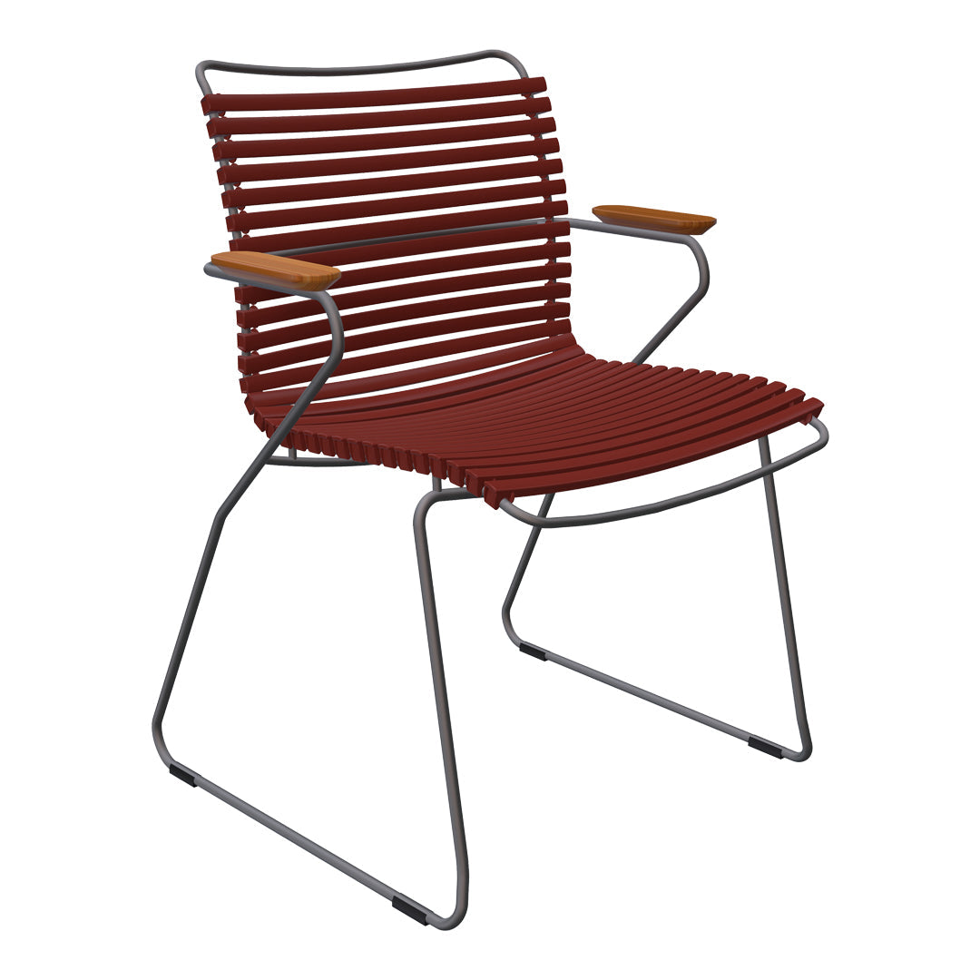 Rust-colored slatted chair with wooden armrests and a sleek metal frame, blending modern design with warm tones.