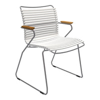 White striped chair with sleek metal frame and wooden armrests, perfect for modern decor.