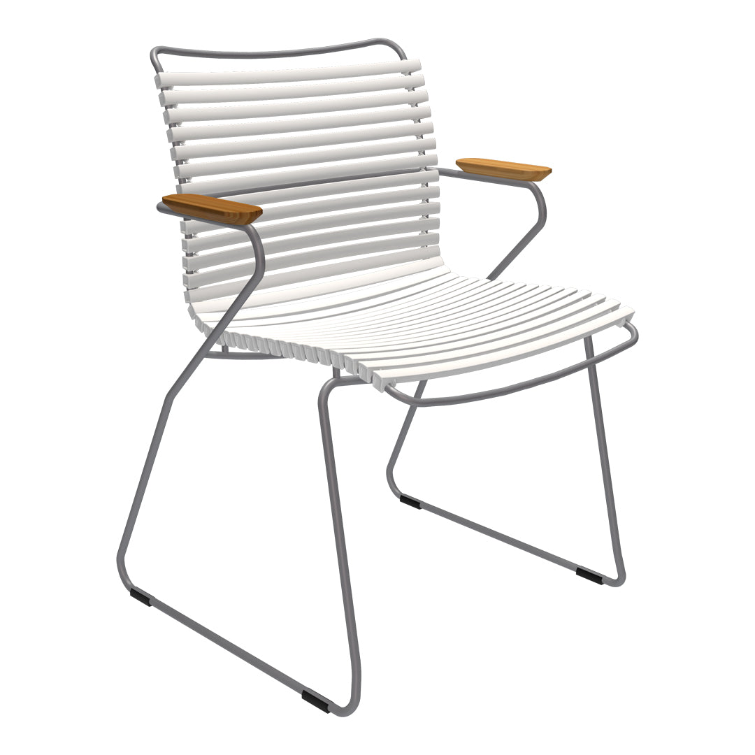 White striped chair with sleek metal frame and wooden armrests, perfect for modern decor.