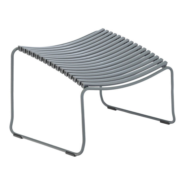 Gray curved slatted ottoman with modern minimalist design, featuring clean lines and a streamlined silhouette.