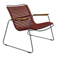 Rust-colored striped lounge chair with a sleek metal frame and wooden armrests. Modern, minimalist design.