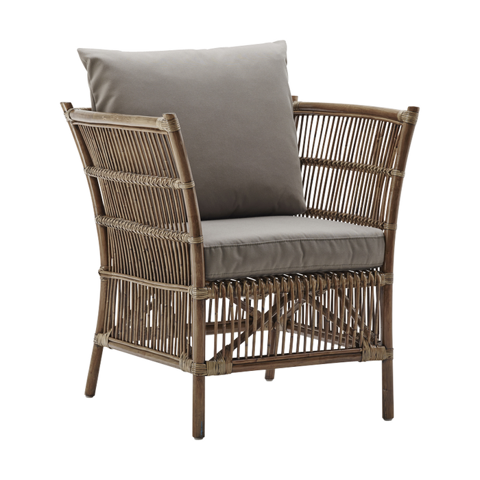 "Natural woven rattan armchair with soft gray cushion, featuring an elegant and contemporary design."