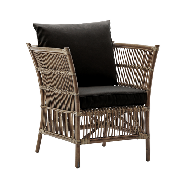 Brown woven chair with black cushion and matching pillow, featuring a contemporary, stylish design.