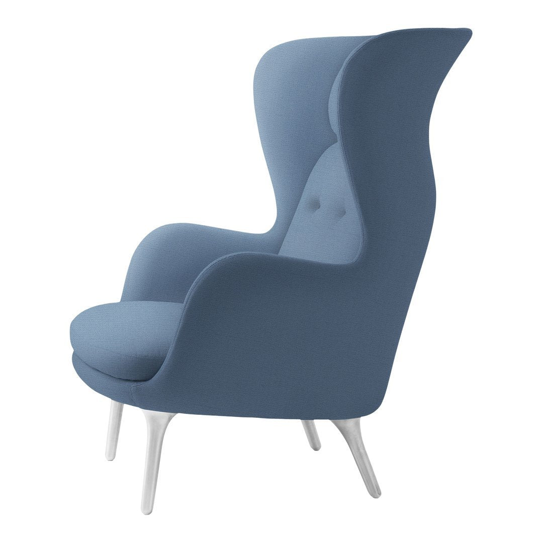 Light blue upholstered chair with a smooth finish and sleek white legs, featuring a unique wingback design.