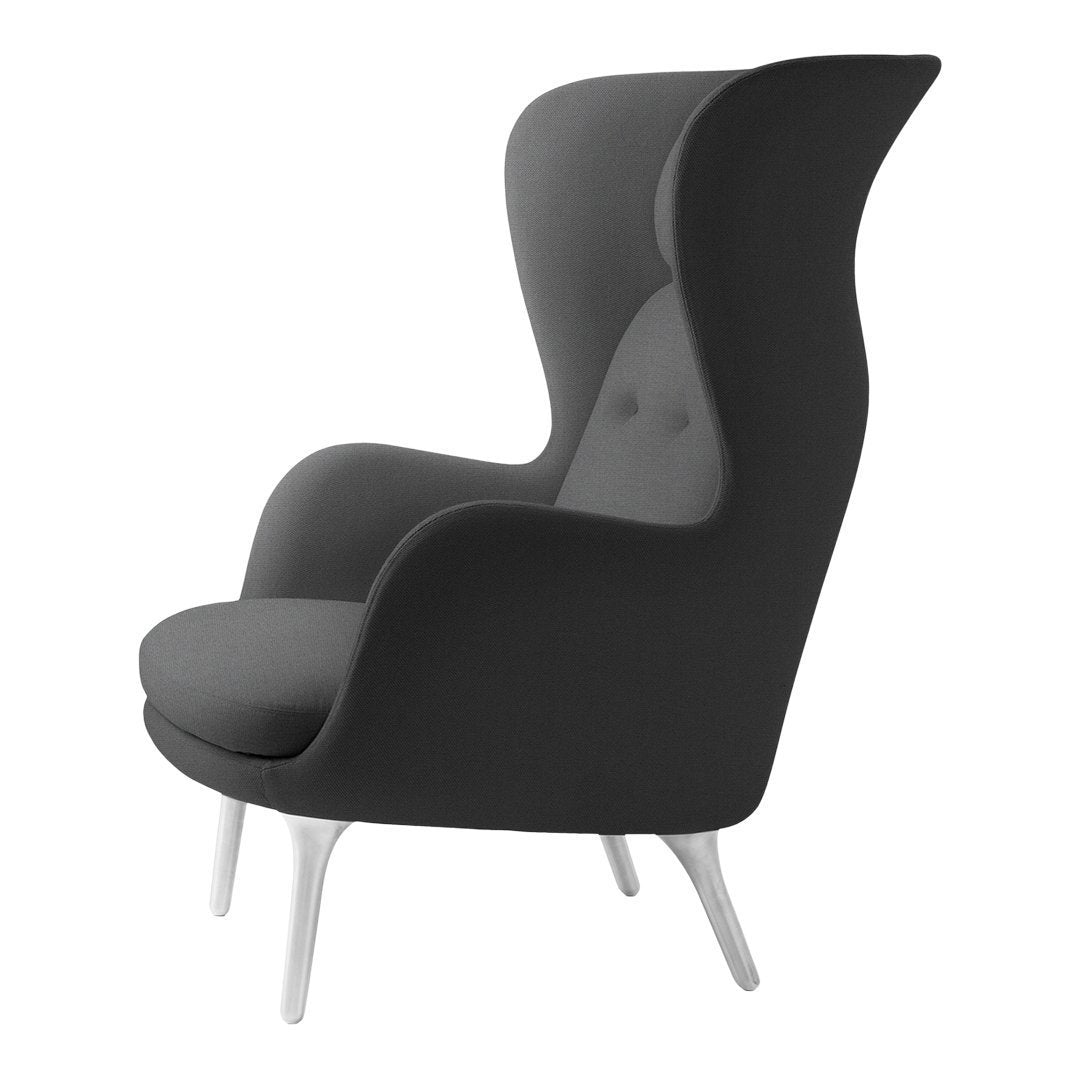 Modern black and gray upholstered chair with sleek design and subtle buttons, set on white legs. Perfect for stylish decor.