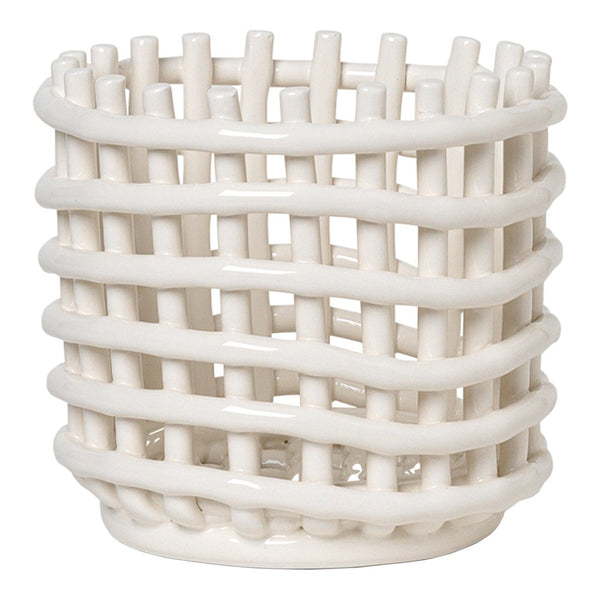 White ceramic basket with a woven pattern, featuring a minimalist design and a smooth texture. Ideal for decor.