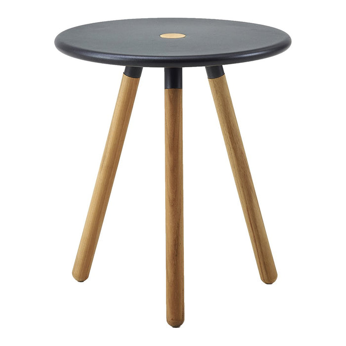 Black circular tabletop with natural wood legs, minimalist design featuring a sleek and modern aesthetic.