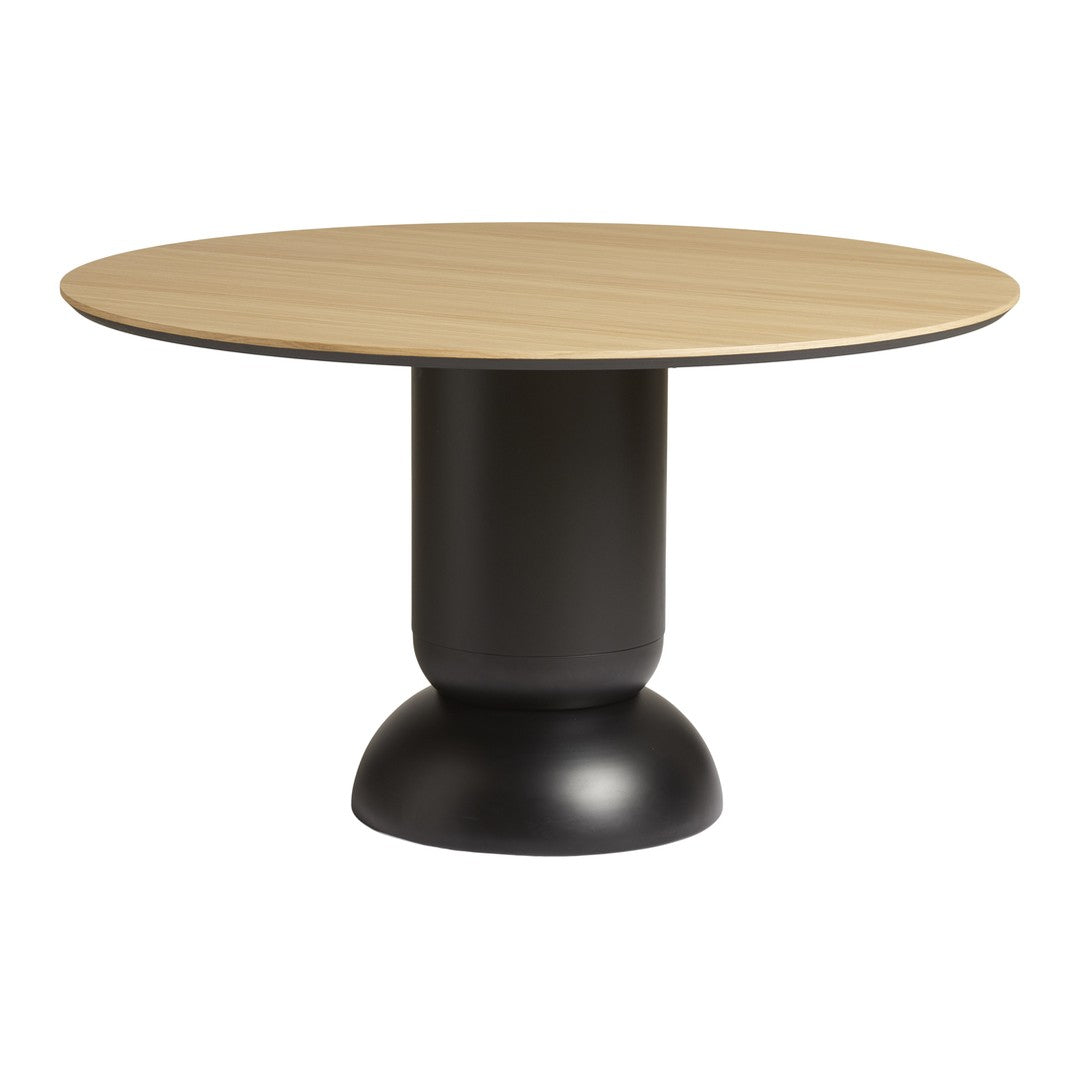 Round oak tabletop with a smooth black pedestal base, showcasing a modern and minimalist design in natural tones.