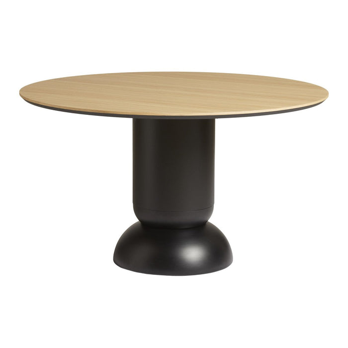 Round oak tabletop with a smooth black pedestal base, showcasing a modern and minimalist design in natural tones.