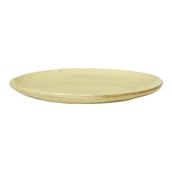 "Round ceramic plate in soft beige with subtle speckles and a smooth, matte finish."