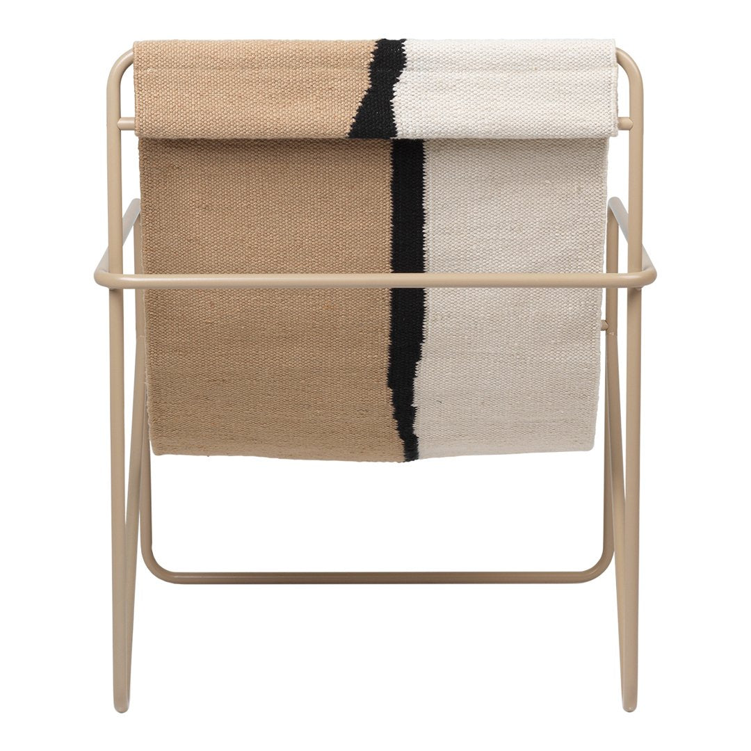 Neutral beige and cream throw blanket with bold black stripe, displayed on a minimal metal frame.