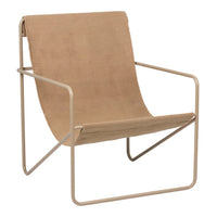 Tan fabric lounge chair with a minimalist design and a light beige metal frame, showcasing a smooth, modern style.