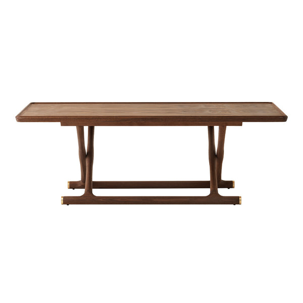 Walnut wood dining table with a smooth surface and sleek, modern design, featuring a rich brown color and subtle grain patterns.