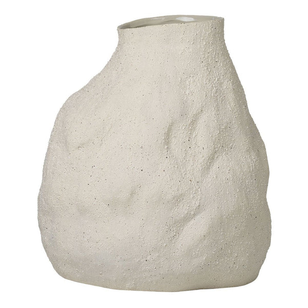 "Textured off-white vase with a unique organic shape, featuring subtle dimples and an uneven surface pattern."