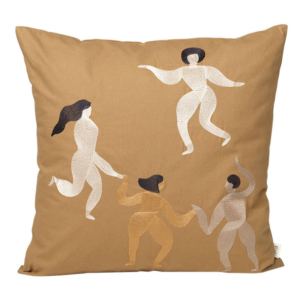 Tan pillow with abstract dancer designs in cream, brown, and black, showcasing playful, artistic patterns.