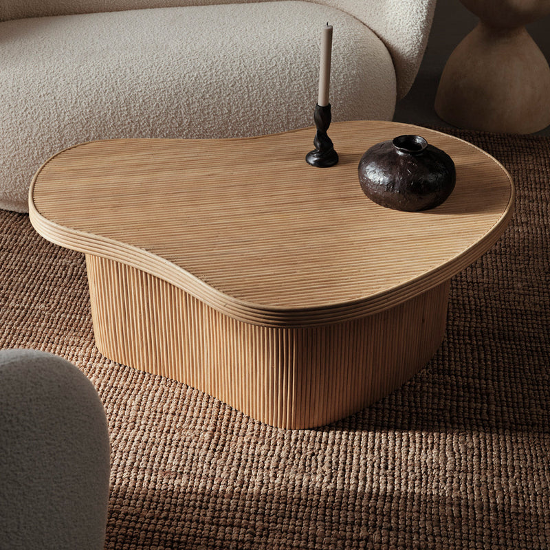 Natural wood coffee table with organic shape, featuring a light finish and textured grain pattern.