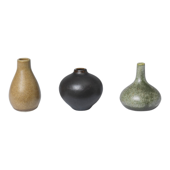Set of three decorative vases in earthy tones: brown, black, and green with sleek, modern shapes and subtle textures.