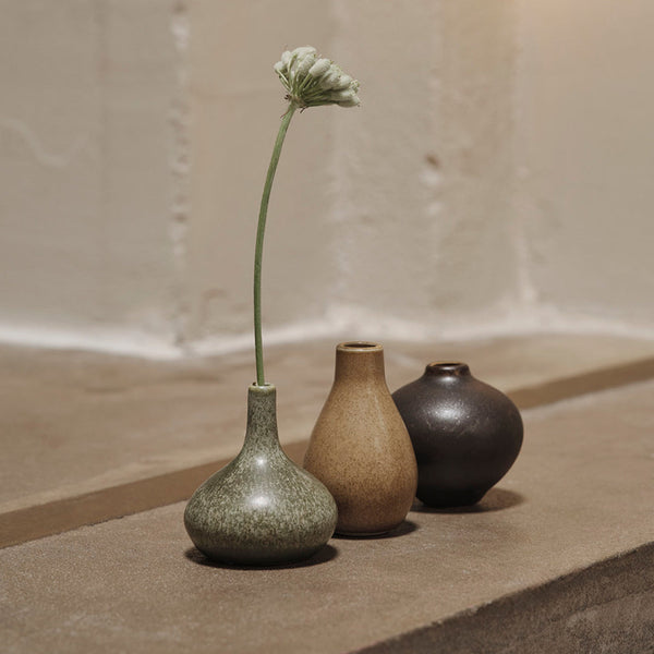Set of three ceramic vases in green, tan, and dark brown with a speckled texture, perfect for elegant decor.