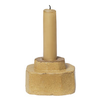 Beige candle holder with a tall, light beige candle, featuring a textured, natural finish. Perfect for rustic decor.