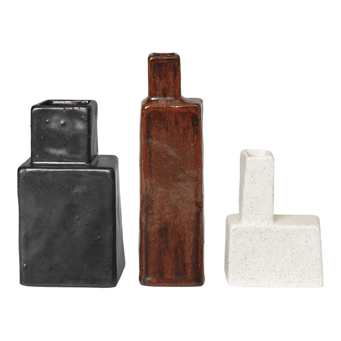 Set of three ceramic vases in black, brown, and white with geometric patterns and varying heights.