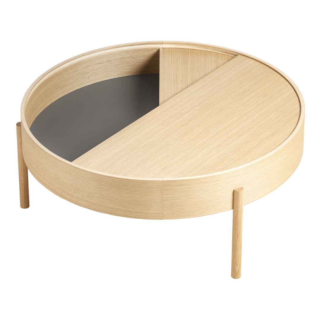 Round wooden coffee table with a natural light wood finish and a dark gray geometric pattern on one side.