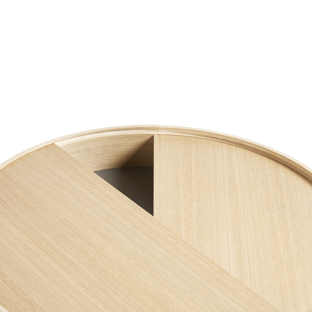 Light oak round table with a smooth natural wood grain and minimalist design, featuring a contrasting dark triangular section.
