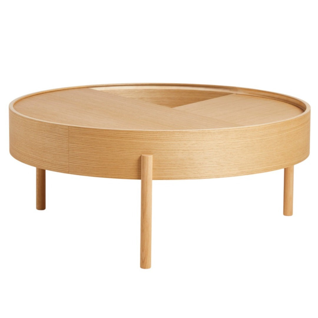 Round wooden coffee table in natural oak finish, featuring a smooth surface and minimalist design with tapered legs.