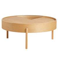 Round wooden coffee table in natural oak finish, featuring a smooth surface and minimalist design with tapered legs.