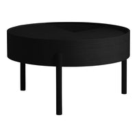 Round black coffee table with a smooth finish and minimalist design, featuring a solid color and sleek legs.