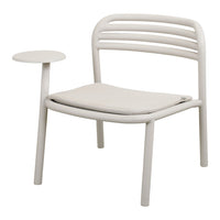 Light beige chair with a curved back, simple lines, and a matching side table, featuring soft cushioned seating.