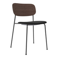 Modern chair featuring a dark wood backrest and a sleek black seat, complemented by sturdy black metal legs.