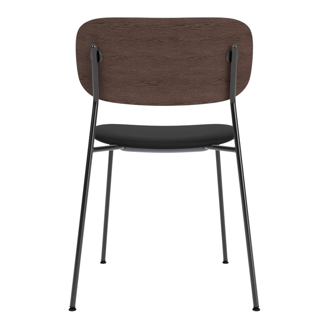 Modern chair with a dark wood backrest, black cushion seat, and sleek black metal legs, perfect for versatile decor.