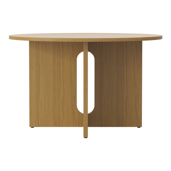Round wooden table with a natural oak finish and minimalist design, featuring a simple cutout pattern on the base.