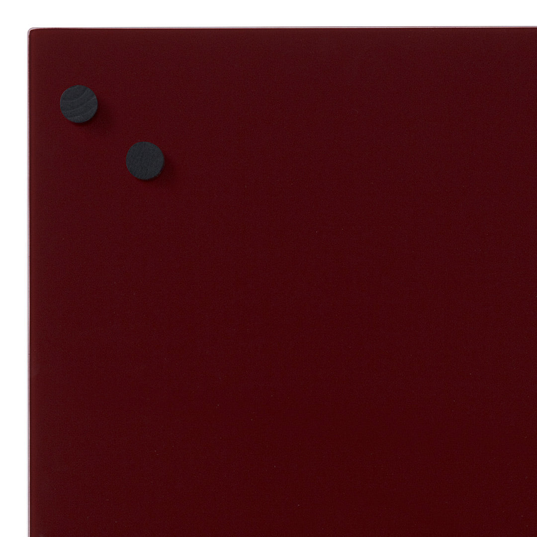 Burgundy background with two round black magnets, creating a sleek, minimalist look. Perfect for modern settings.