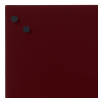 Burgundy background with two round black magnets, creating a sleek, minimalist look. Perfect for modern settings.