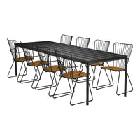 Black metal dining table with sleek lines, paired with wire chairs featuring warm wooden seats. Elegant modern design.
