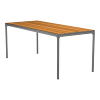 Rectangular dining table with a warm, slatted wooden top and sleek gray metal legs. Modern and minimalistic design.
